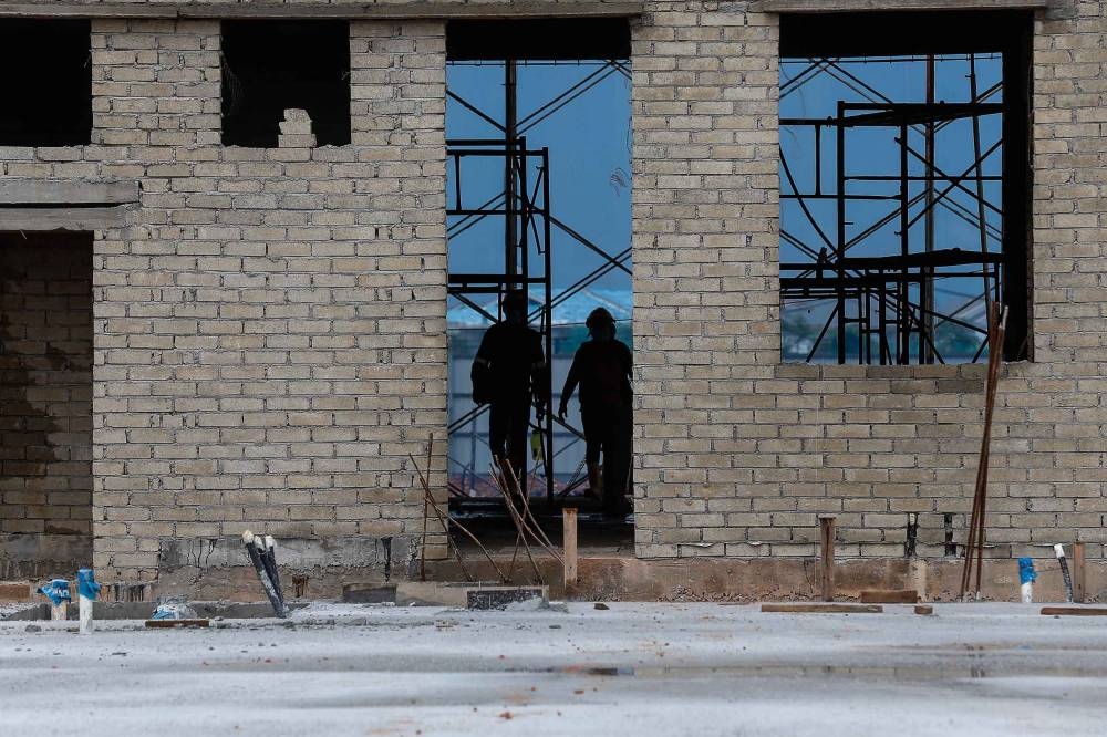 Foreign workers are pictured in the construction yard during an operation by the police, Construction Industry Development Board (CIDB) and local authorities in Bertam May 27, 2021. — Picture by Sayuti Zainudin