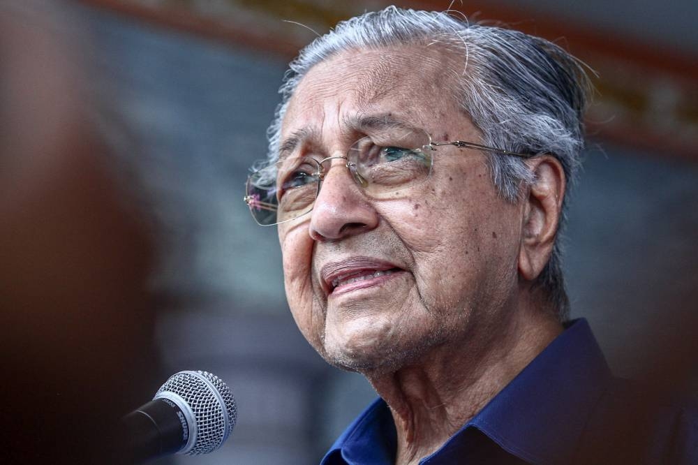 Pejuang chairman Tun Dr Mahathir Mohamad speaks during his visit to Felda Ayer Hitam to help campaigning for Pejuang's candidates ahead of the state election March 3, 2022. — Picture by Hari Anggara