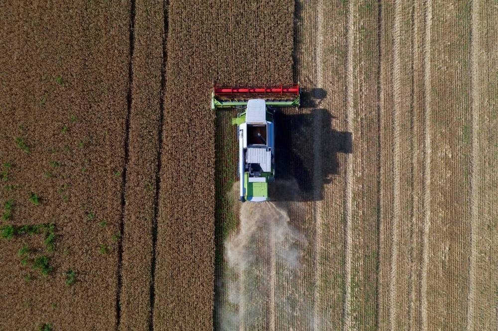 In this file aerial photo taken on July 14, 2022 farmers harvest a wheat field near Melitopol, Zaporizhzhia region, amid the ongoing Russian military action in Ukraine. ― AFP pic