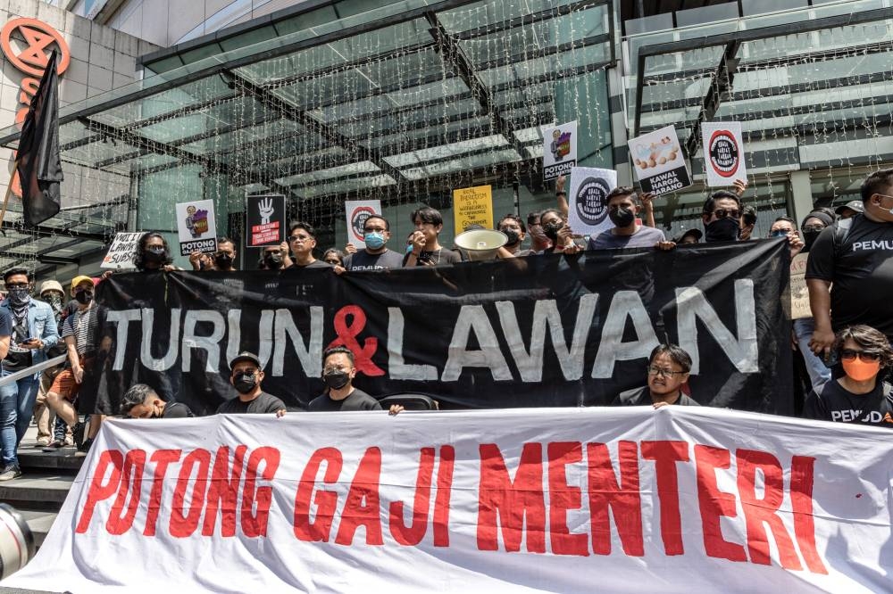 Protesters hold banners during the 'Turun' protest at Sogo shopping complex in Kuala Lumpur, July 23, 2022. — Picture by Firdaus Latif