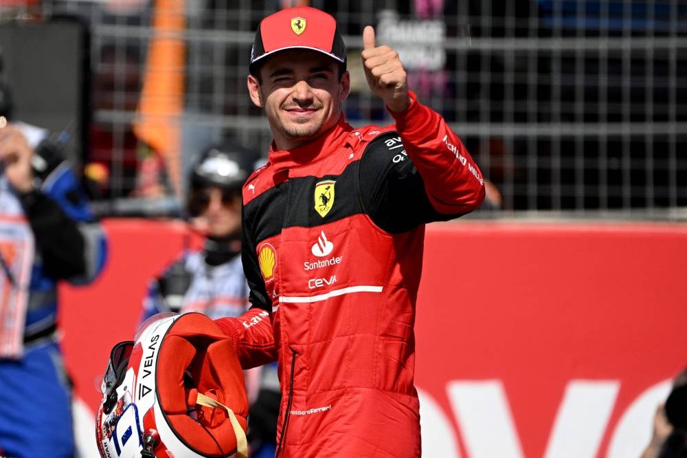 Ferrari's Monegasque driver Charles Leclerc salutes the crowd after he took the pole position during the qualifying session ahead of the French Formula One Grand Prix at the Circuit Paul Ricard in Le Castellet, southern France, on July 23, 2022. — AFP pic