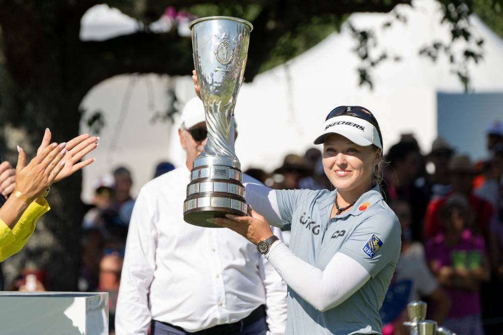 Brooke Henderson of Canada celebrates with the trophy after winning the Evian Championship in the French Alps town of Evian-les-Bains, a major tournament on the women's calendar July 24, 2022. — AFP pic