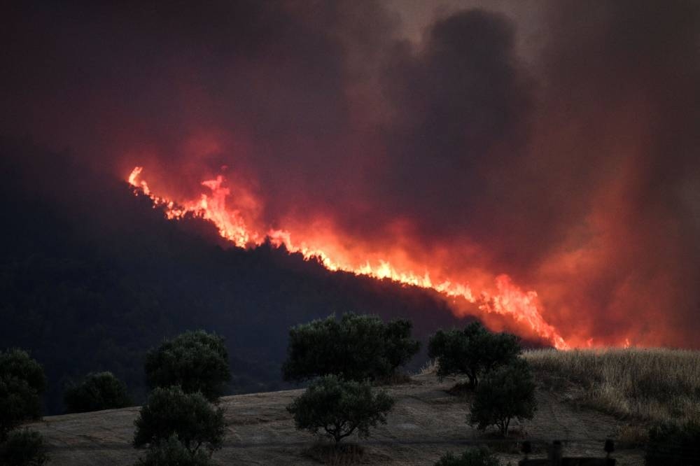 A wildfire burns at the village of Krestena, in the western Peloponnese, Greece July 24, 2022. — Picture by Giannis Spirounis/Eurokinissi via Reuters