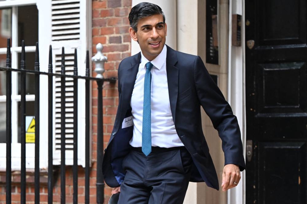 Rishi Sunak's (pic) pledge comes after his rival in the final two of the race to lead the ruling Conservative party, Liz Truss, accused him of being weak on China and Russia. — AFP pic