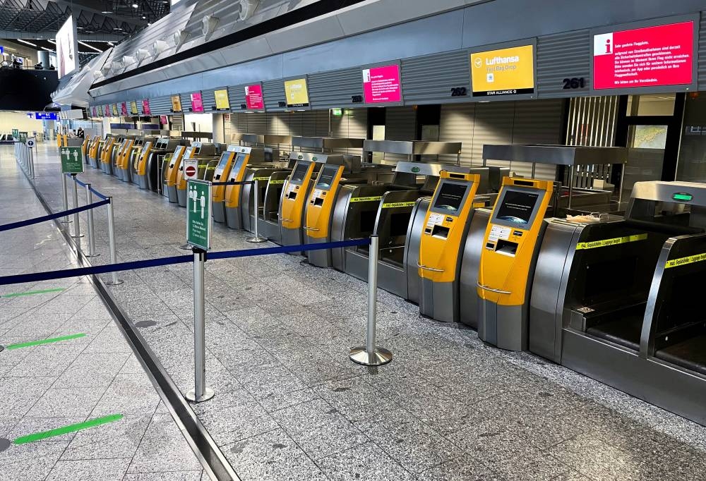 Empty counters of German airline Lufthansa at Frankfurt Airport are pictured during a strike of security staff at various German airports, March 15, 2022. — Reuters pic