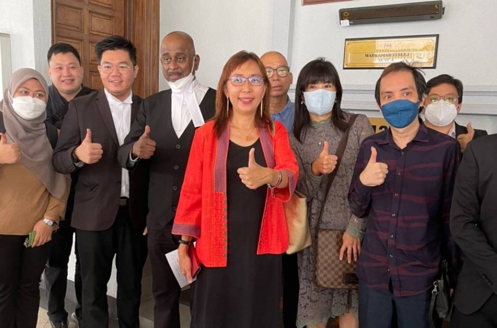 Teresa Kok and her legal team pose for the cameras at the High Court in Kuala Lumpur July 26, 2022. — Picture by Zarrah Morden
