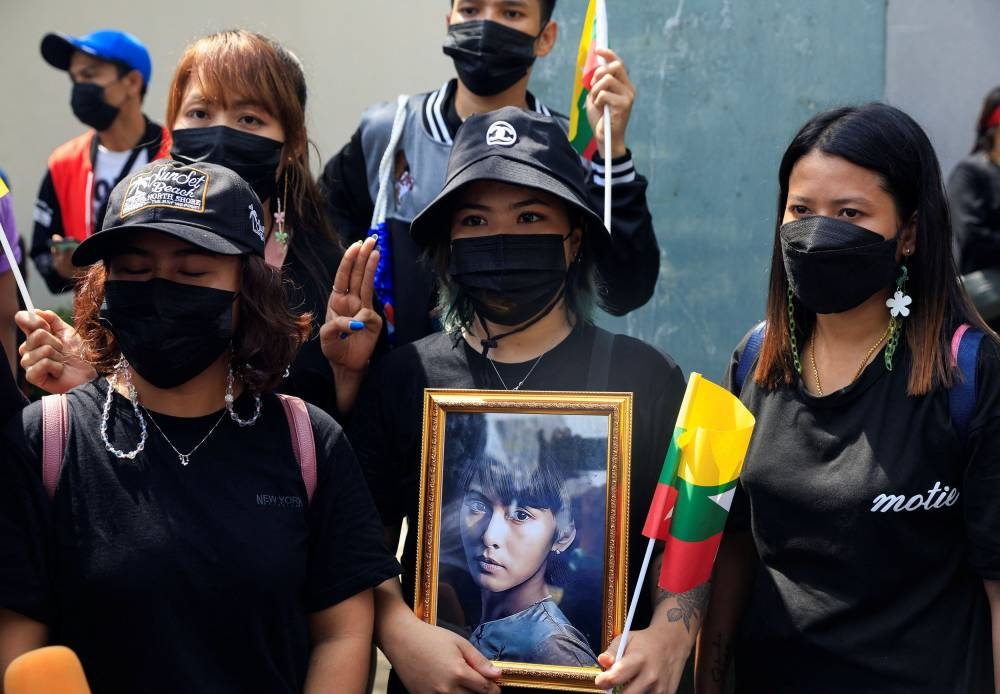 Myanmar citizens who live in Thailand, hold a portrait of former Myanmar state counsellor Aung San Suu Kyi as they protest against the execution of pro-democracy activists, at Myanmar embassy in Bangkok, Thailand July 26, 2022. — Reuters pic