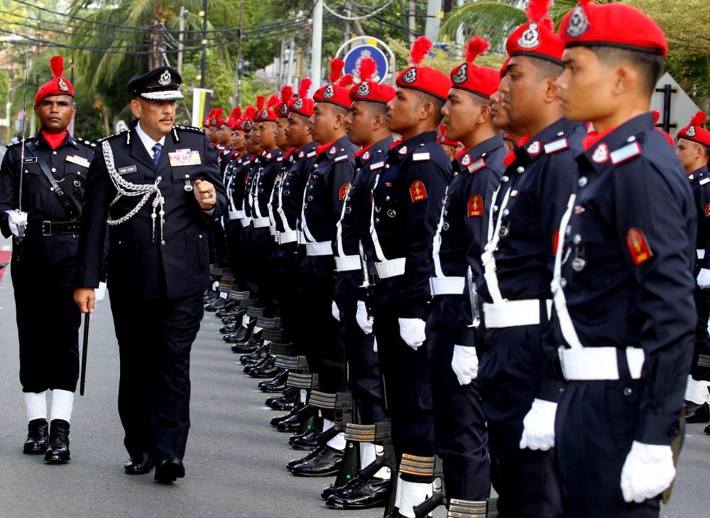 Perak police chief Datuk Mior Faridalathrash Wahid inspecting the guard of honour at the opening the Pulau Pangkor police station, July 27, 2022. — Bernama pic 