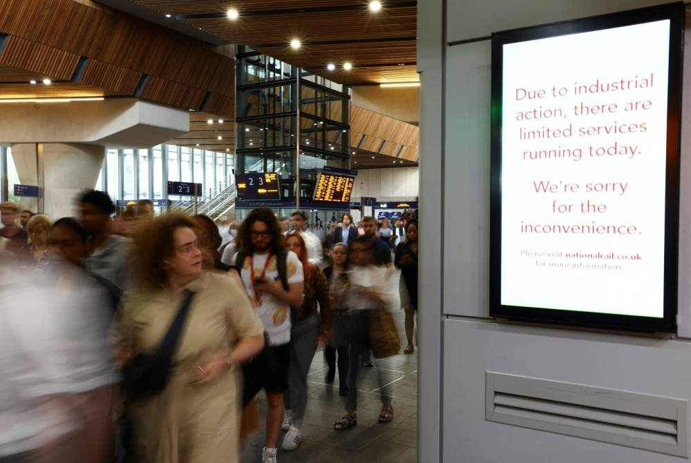 People walk at the London Bridge station, during a rail strike in London July 27, 2022. — Reuters pic