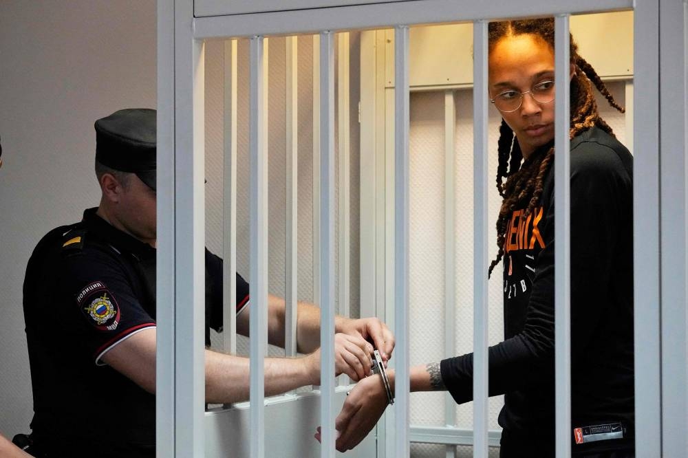 US WNBA basketball superstar Brittney Griner gets handcuffs taken off before a hearing at the Khimki Court, outside Moscow, July 27, 2022. — AFP pic 
