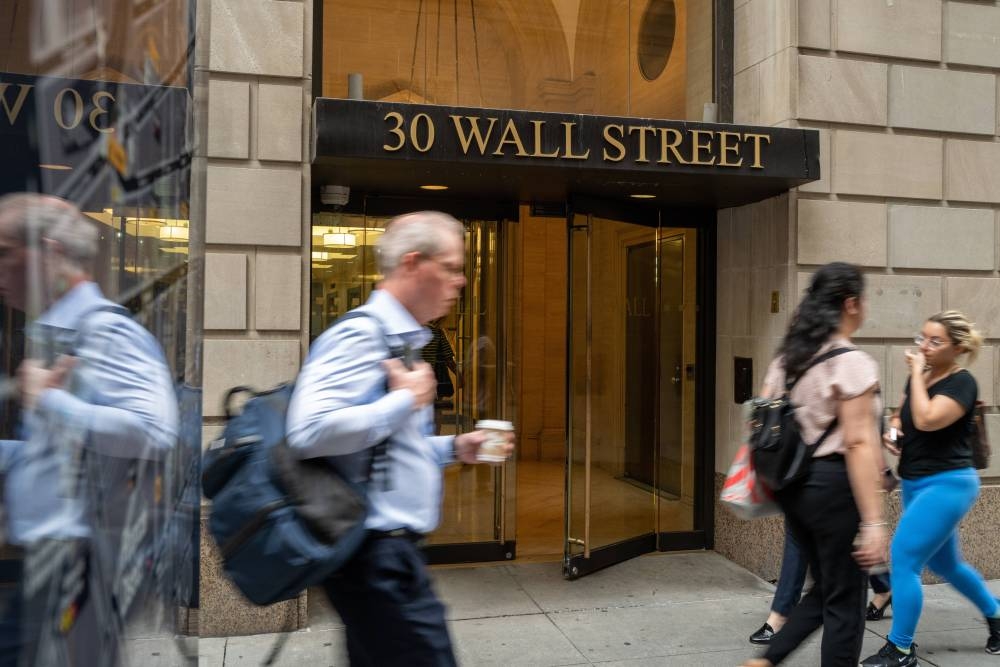 People walk outside of the New York Stock Exchange (NYSE) on July 25, 2022 in New York City. — Spencer Platt/Getty Images/AFP pic