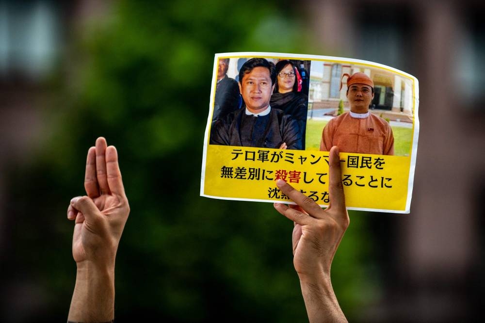 An activist takes part in a rally to protest against Myanmar's junta execution of four prisoners, including including a former lawmaker from Aung San Suu Kyi's party, outside the United Nations University in Tokyo on July 26, 2022. — AFP pic
