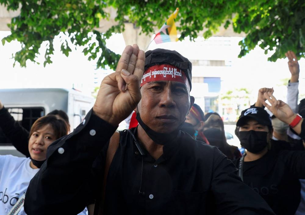 Myanmar citizens who live in Thailand, show three fingers as they protest against the execution of pro-democracy activists, at Myanmar embassy in Bangkok, Thailand July 26, 2022. — Reuters pic
