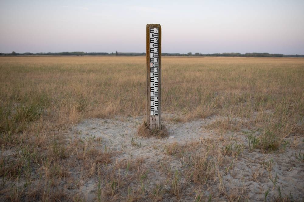 A water level meter stands in the middle of the dried up Kondor Lake near Kerekegyhaza, Hungary, July 21, 2022. — Reuters pic