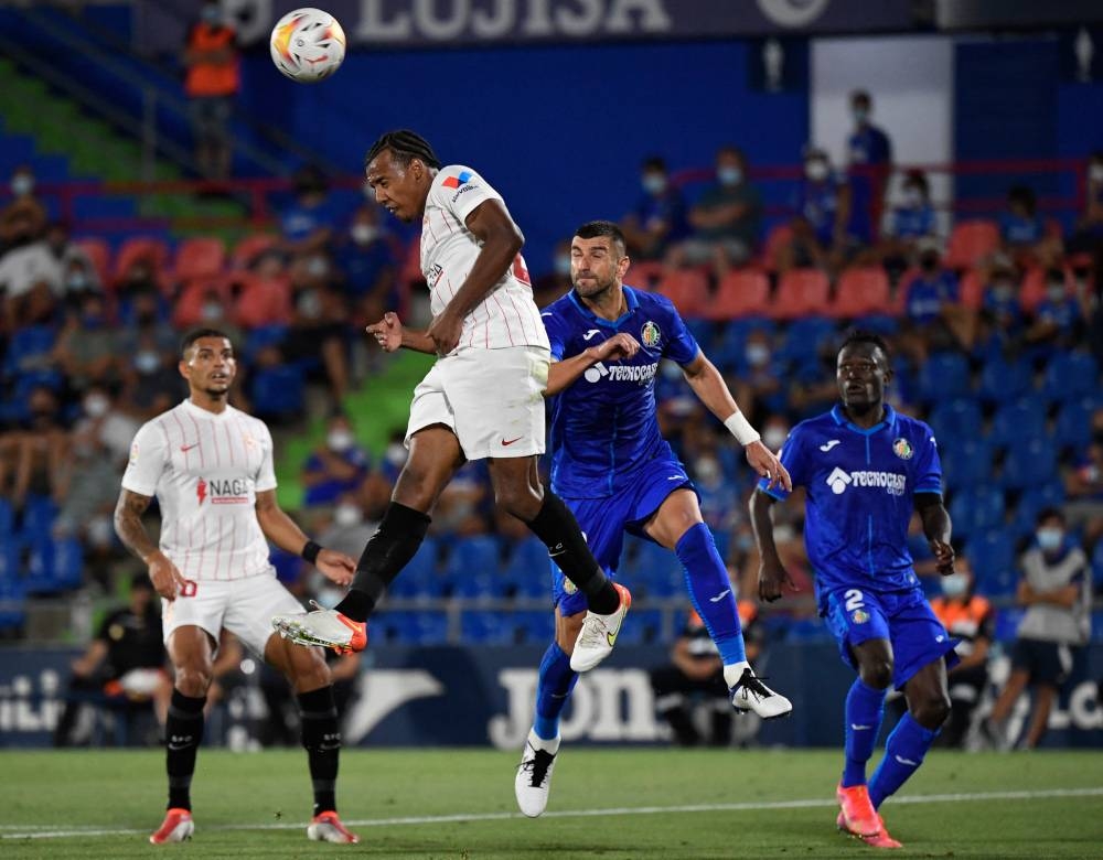 Sevilla’s French defender Jules Kounde (2nd left) heads the ball during the Spanish League football match between Getafe CF and Sevilla FC at the Col. Alfonso Perez stadium in Getafe, August 22, 2021. — AFP pic