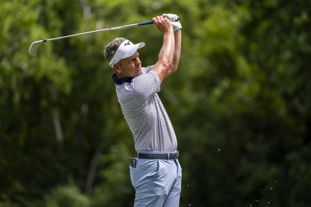 Luke Donald tees off on the par 3 ninth hole during the first round of the Rocket Mortgage Classic golf tournament in Detroit July 28, 2022. — Reuters pic 