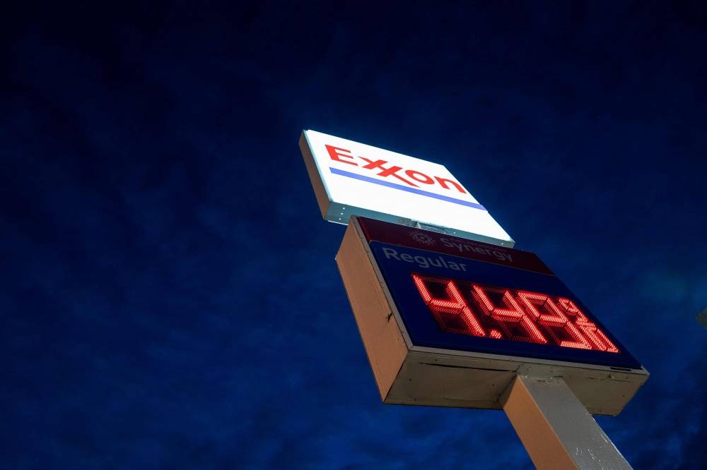 In this file photo taken on March 13, 2022, a sign displays the price of gas at an Exxon gas station in Washington, DC. - ExxonMobil's profits nearly quadrupled to US$17.9 billion in results released on July 29, 2022, that underscored the elevated state of oil and natural gas prices amid commodity market tightness. The US oil giant saw profits of US$4.7 billion in the year-ago period. Revenues rose 68.7 per cent to US$111.3 billion. — AFP pic