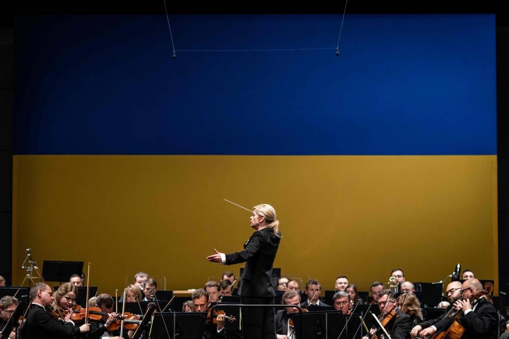Musicians from the Ukrainian Freedom Orchestra lead by conductor Kerii-Lynn Wilson take part in a rehearsal in Warsaw Opera before their international tour, July 28, 2022. — AFP pic