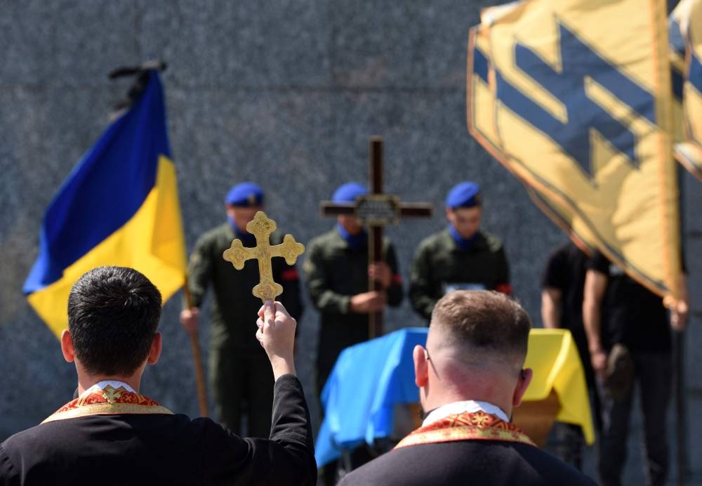 Ukrainian soldiers attend the funeral ceremony of Vasyl Sushchuk, a serviceman of the Azov regiment killed during the Russian invasion of Ukraine, at the Lychakiv cemetery in the western Ukrainian city of Lviv, on July 29, 2022. — AFP pic