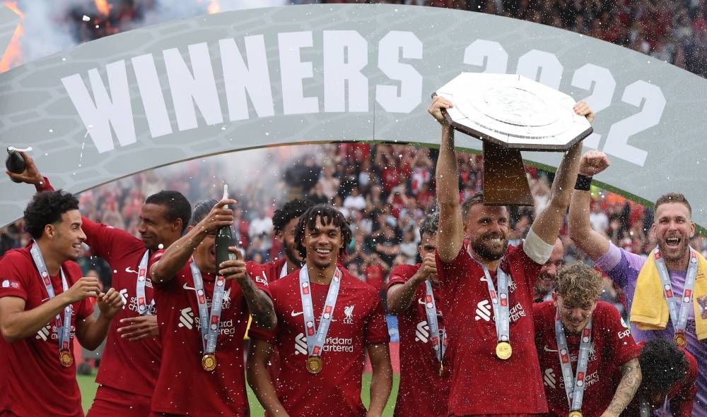 Liverpool's team players celebrates with the trophy after winning the English FA Community Shield football match between Liverpool and Manchester City at the King Power Stadium in Leicester on July 30, 2022. — AFP pic