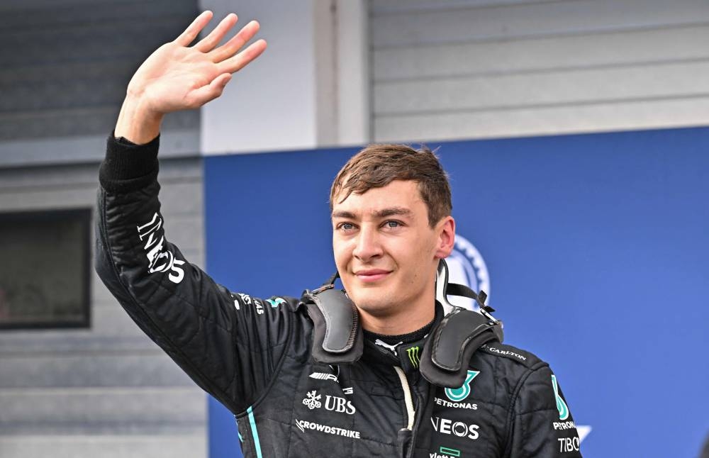First placed Mercedes' British driver George Russell waves after winning the pole position during the qualifying session ahead of the Formula One Hungarian Grand Prix at the Hungaroring in Mogyorod near Budapest, Hungary July 30, 2022. — AFP pic