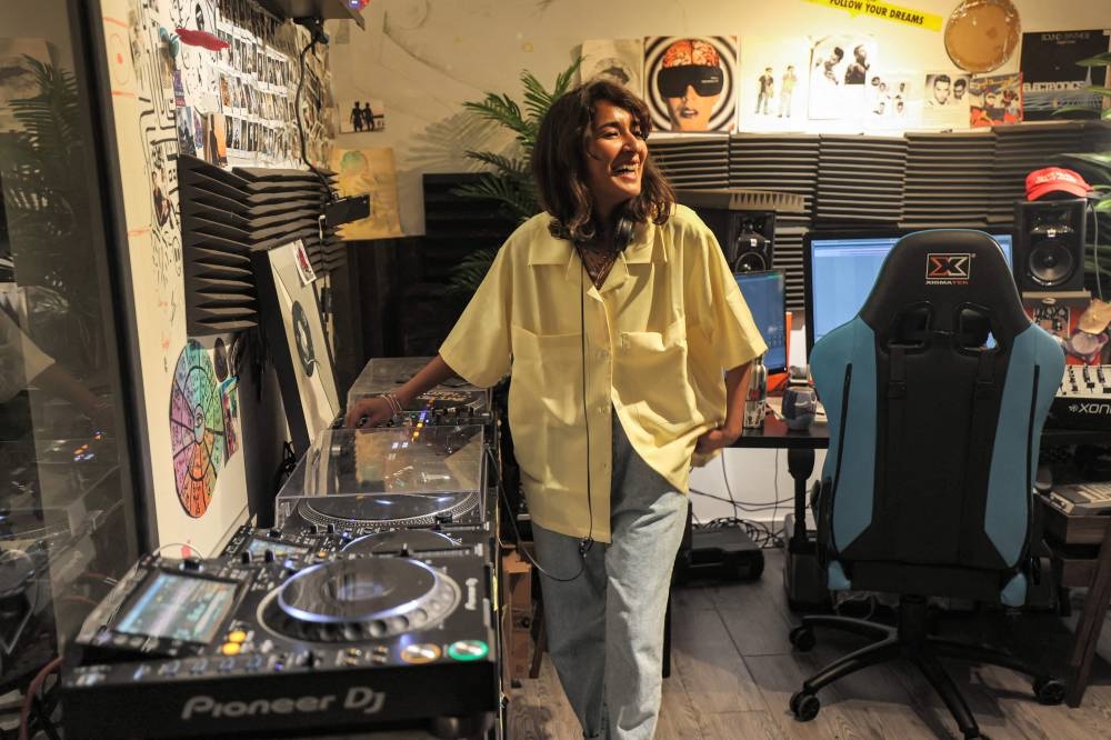 Saudi DJ Lujain Albishi plays at a beach event in Saudia Arabia's Red Sea city of Jeddah on May 26, 2022. — AFP pic