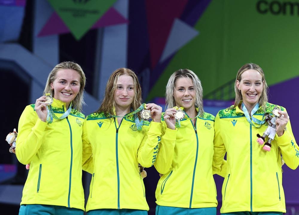Australia's Ariarne Titmus, Mollie O'Callaghan, Madison Wilson and Kiah Melverton celebrate on the podium during the medal ceremony, Birmingham July 31, 2022. — Reuters pic