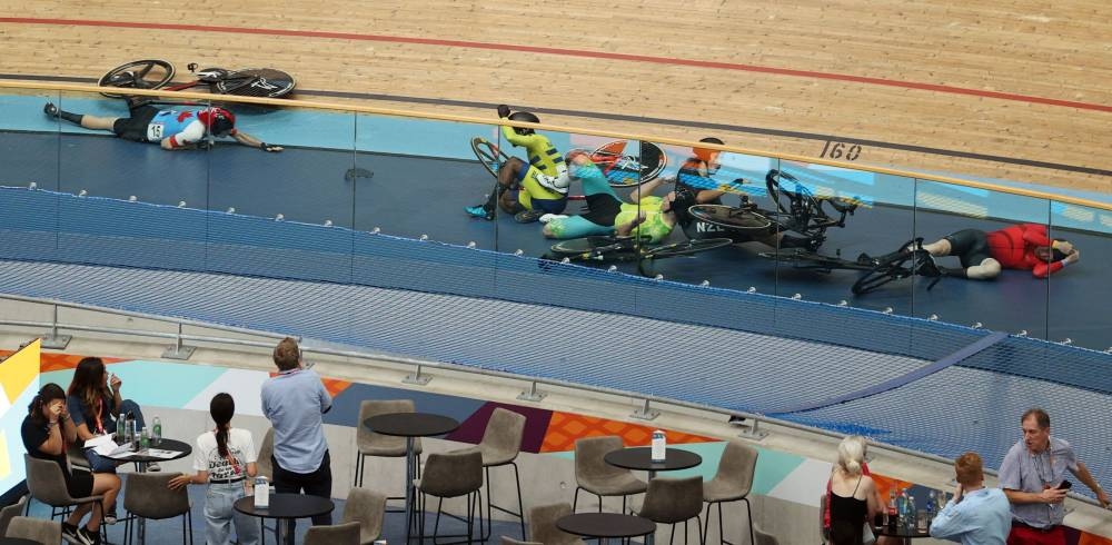 Riders lie on the track following a massive crash during the men's 15km scratch race qualifying round cycling event on day three of the Commonwealth Games, at the Lee Valley VeloPark in east London, on July 31, 2022. — AFP pic