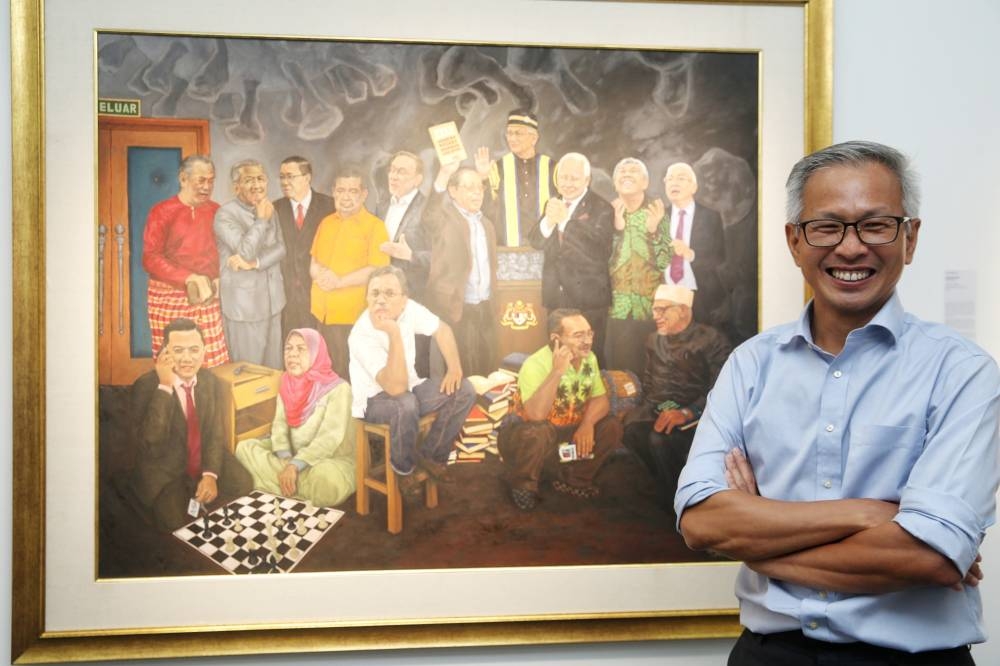Tony Pua poses with his painting 'Langkah Sheraton' which will be sold as part of DAP's GE15 fundraiser 'Langkah Sheraton NFTs' at Impian Theatre, Plaza Bukit Jalil on August 1, 2022. — Photo by Choo Choy May