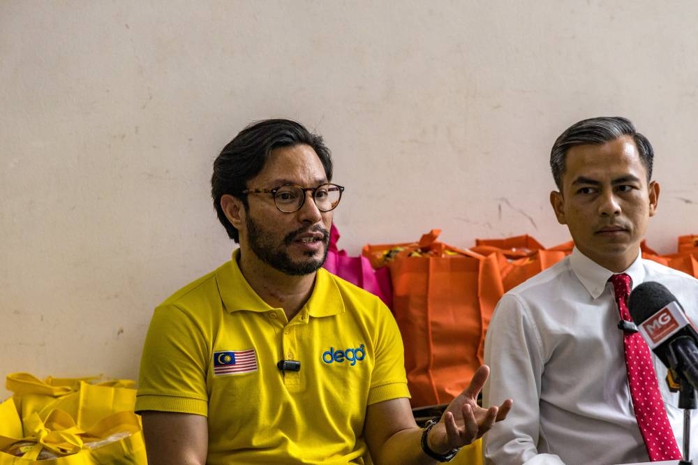 Dego Ride founder and CEO Nabil Feisal Bamadhaj (left) speaks during a press conference with Lembah Pantai MP Fahmi Fadzil in Kuala Lumpur on August 2, 2022. — Picture by Firdaus Latif