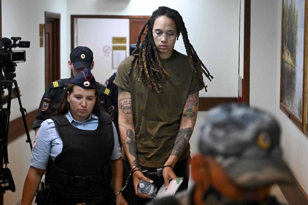 US basketball player Brittney Griner is escorted by police before a hearing during her trial on charges of drug smuggling, in Khimki, outside Moscow, August 2, 2022. — AFP pic 