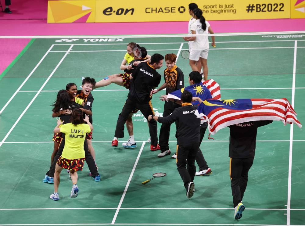 The Malaysia team celebrate beating India in the Mixed Team Gold Medal badminton match on day five of the Commonwealth Games at the NEC Arena in Birmingham, central England, August 2, 2022. — AFP pic 
