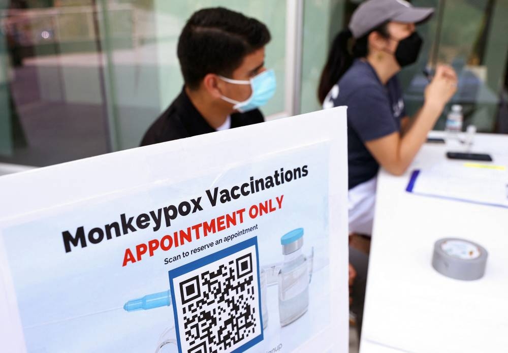 In this file photo taken on August 3, 2022 health workers sit at a check-in table at a pop-up monkeypox vaccination clinic which opened today by the Los Angeles County Department of Public Health at the West Hollywood Library in West Hollywood, California. — AFP pic