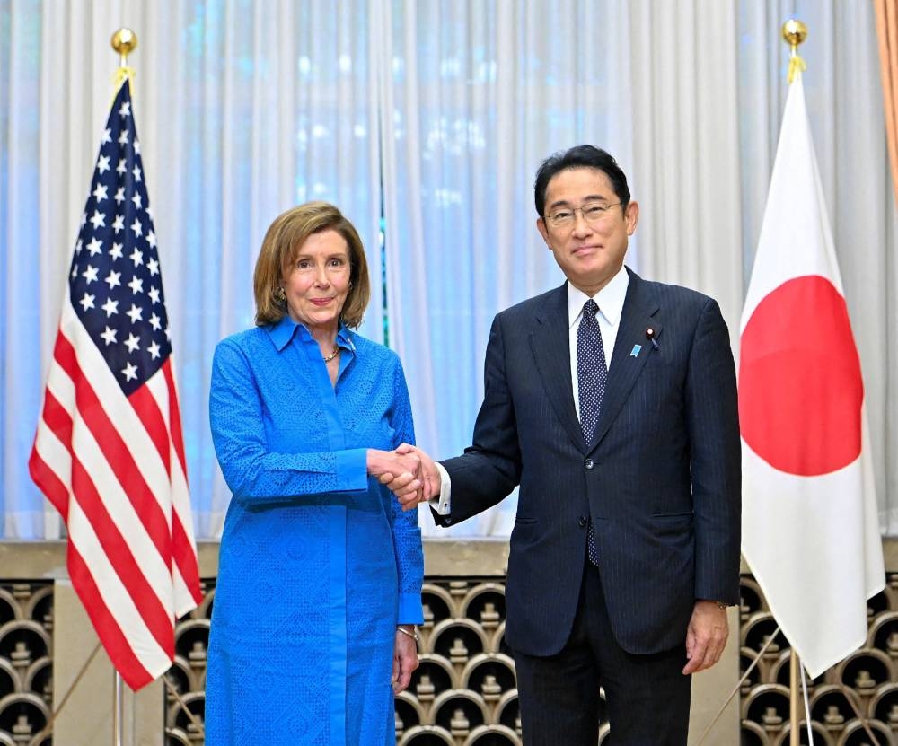 US House Speaker Nancy Pelosi shakes hands with Japanese Prime Minister Fumio Kishida during a meeting at the prime minister's official residence in Tokyo August 5, 2022. — AFP pic