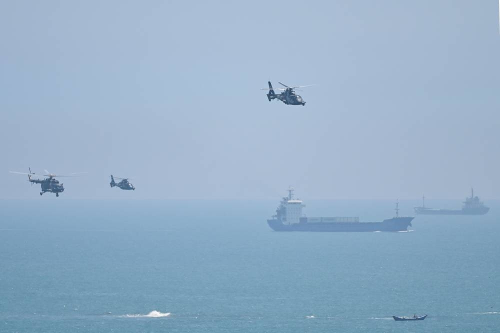 Chinese military helicopters fly past Pingtan island, one of mainland China's closest point from Taiwan, in Fujian province on August 4, 2022, ahead of massive military drills off Taiwan following US House Speaker Nancy Pelosi's visit to the self-ruled island. — AFP pic