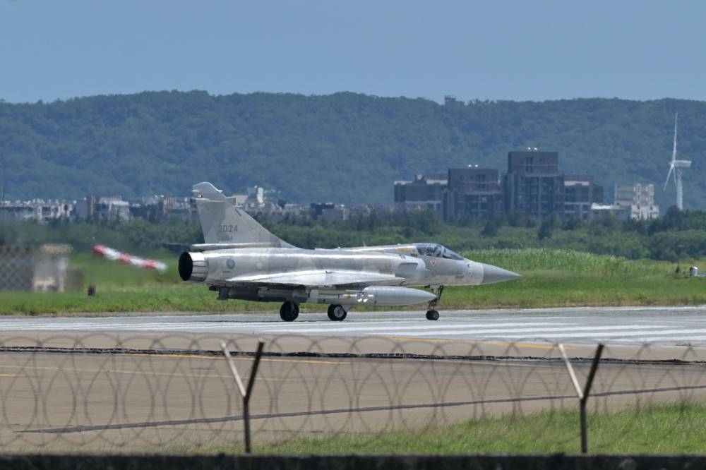 A French-made Mirage 2000 fighter jet taxis on a runway in front of a hangar at the Hsinchu Air Base in Hsinchu on August 5, 2022. — AFP pic