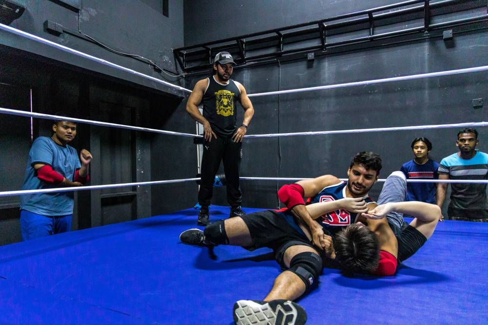 ‘Class is in progress’ — Malaysian pro-wrestler and wrestling coach, Ayez Shaukat-Fonseka Farid coaching his class at Apac Wrestling in Kota Damansara. — Picture by Firdaus Latif