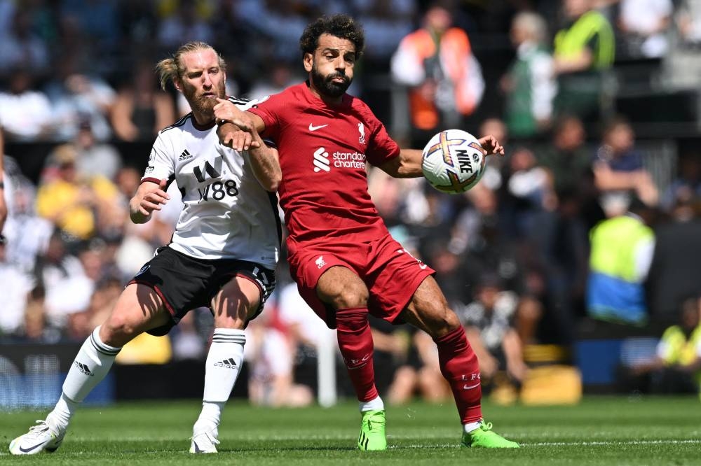 Fulham’s US defender Tim Ream (left) vies with Liverpool’s Egyptian striker Mohamed Salah (right) during the English Premier League football match between Fulham and Liverpool at Craven Cottage in London on August 6, 2022. — AFP pic