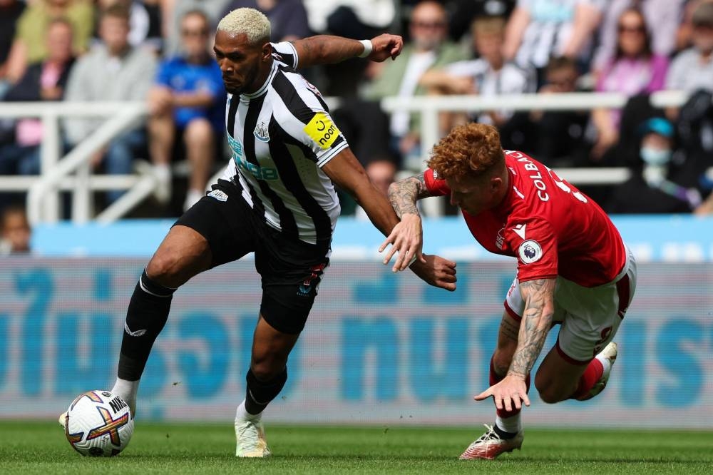 Newcastle United’s Brazilian striker Joelinton (left) fights for the ball with Nottingham Forest’s English midfielder Jack Colback during the English Premier League football match between Newcastle United and Nottingham Forest at St James’ Park in Newcastle-upon-Tyne, north east England on August 6, 2022. — AFP pic