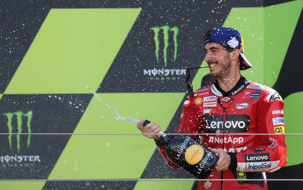 Ducati Lenovo's Francesco Bagnaia celebrates with champagne on the podium after winning the British Grand Prix at the Silverstone Circuit, Silverstone, Britain August 7, 2022. — Reuters pic