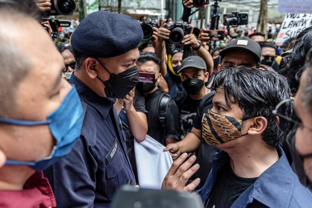Protesters and police officers face off at the 'Turun' protest at Sogo shopping complex, in Kuala Lumpur July 23, 2022. — Picture by Firdaus Latif
