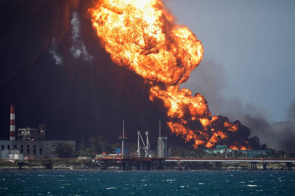 Fire is seen over fuel storage tanks that exploded near Cuba's supertanker port in Matanzas, Cuba August 8, 2022. ― Reuters pic