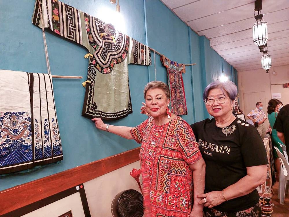Socialite See Foon-Chan Koppen (left) with Perak Women for Women president Kimberley Tan during the launching of Tales of Collecting exhibition at Jalan Market, Ipoh. —  Picture by Sylvia Looi