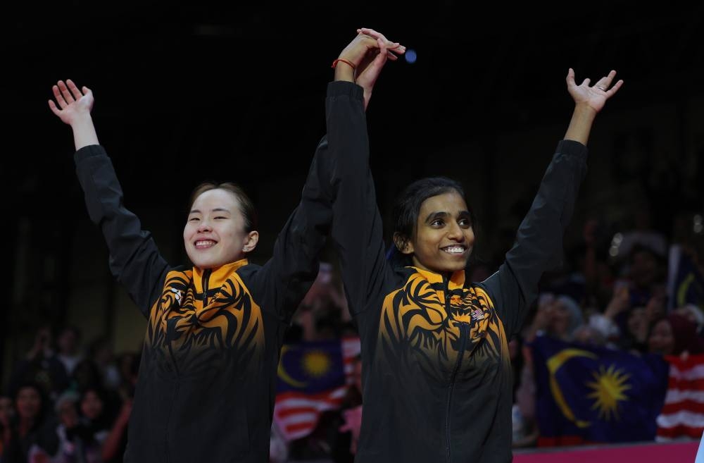 Pearly Tan and M Thinaah  presented the seventh gold medal to the Malaysian contingent on the last day of the Games after trouncing England’s duo, Chloe Birch-Lauren Smith 21-5, 21-8 in the final at the National Exhibition Centre. — Bernama pic