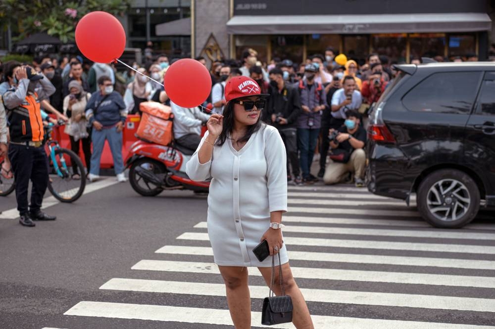 This picture taken on July 22, 2022 shows an Indonesian youth presenting a self-styled fashion creation at a pedestrian crossing turned catwalk, part of a gathering in recent weeks dubbed 'Citayam Fashion Week', in Jakarta. –- AFP pic 