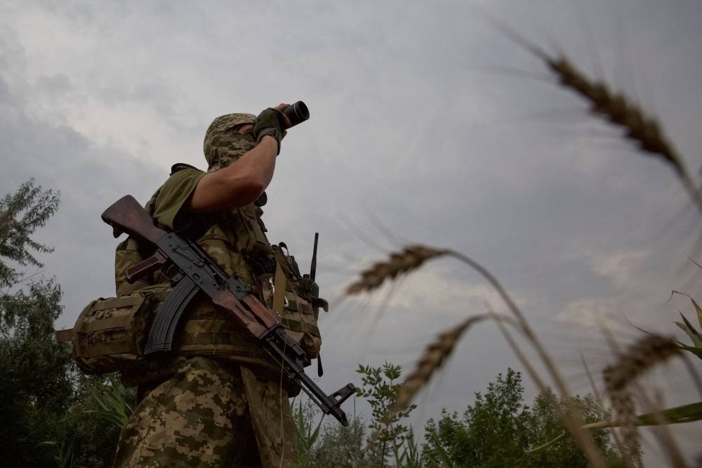 A Ukrainian serviceman checks an area at a position in a front line in Mykolaiv region, as Russia's attack on Ukraine continues, Ukraine August 11, 2022. ― Reuters pic
