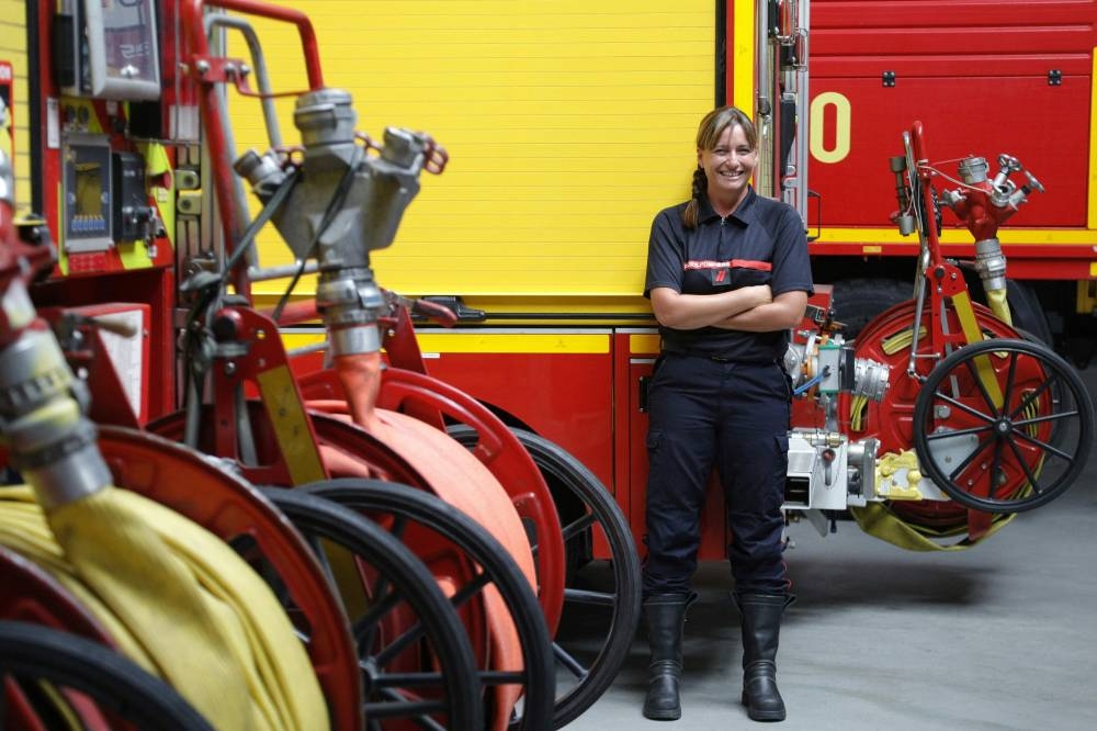 French volunteer firefighter Aurelie Ponzevera poses next to a firefighter truck at the Ajaccio’s fire station, in Ajaccio, on the French Mediterranean island of Corsica on August 12, 2022. — AFP pic