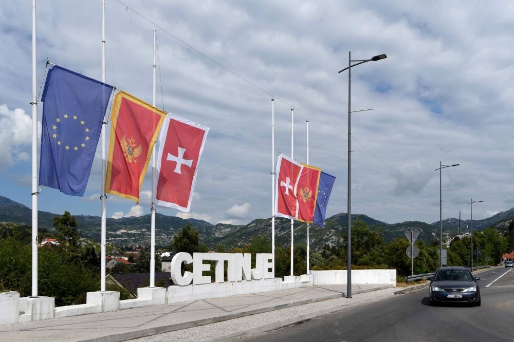 This picture taken on August 13, 2022, shows flags at half-mast after a mass shooting in the town of Cetinje, in Montenegro. — AFP pic