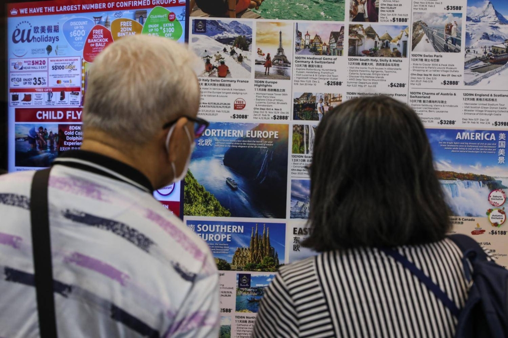 People checking out places to visit in Europe at the Natas fair on Aug 12, 2022. — TODAY pic