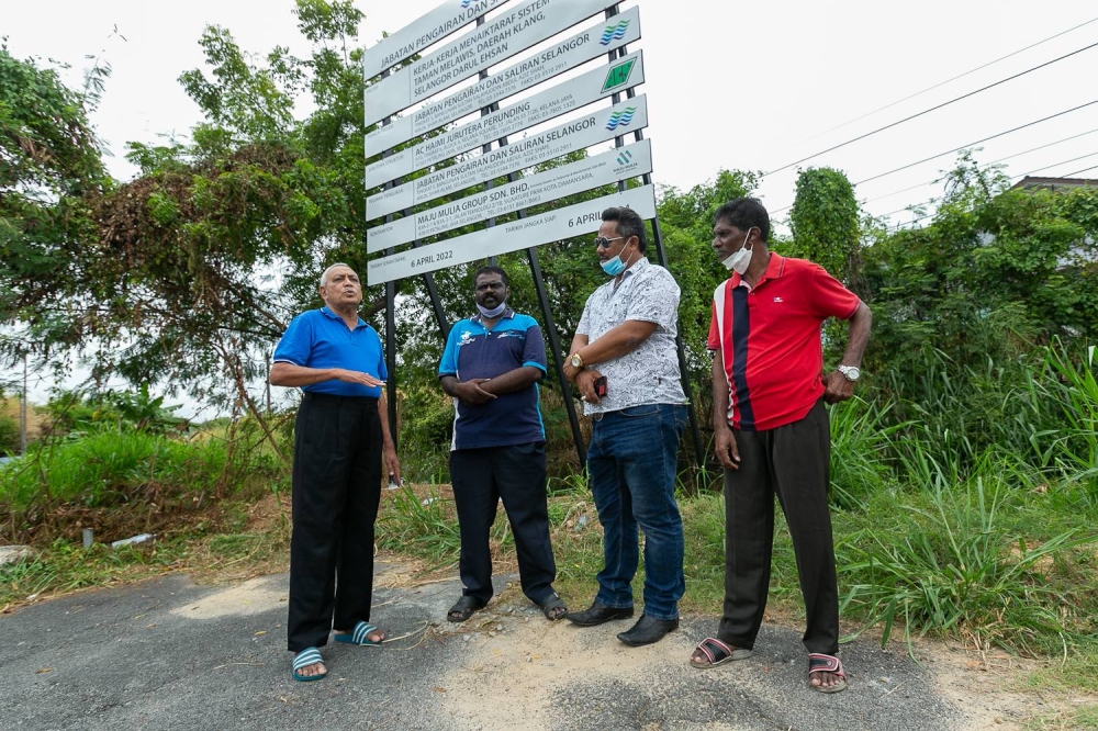 Long time residents (from left) Serjeet Singh, Meganathan Ariginam, Alfian Zim, Paratheman Muthu, at the site where a culvert to redirect rainwater is meant to be built in Jalan Loyang, Taman Melawis, Klang. — Picture by Devan Manuel